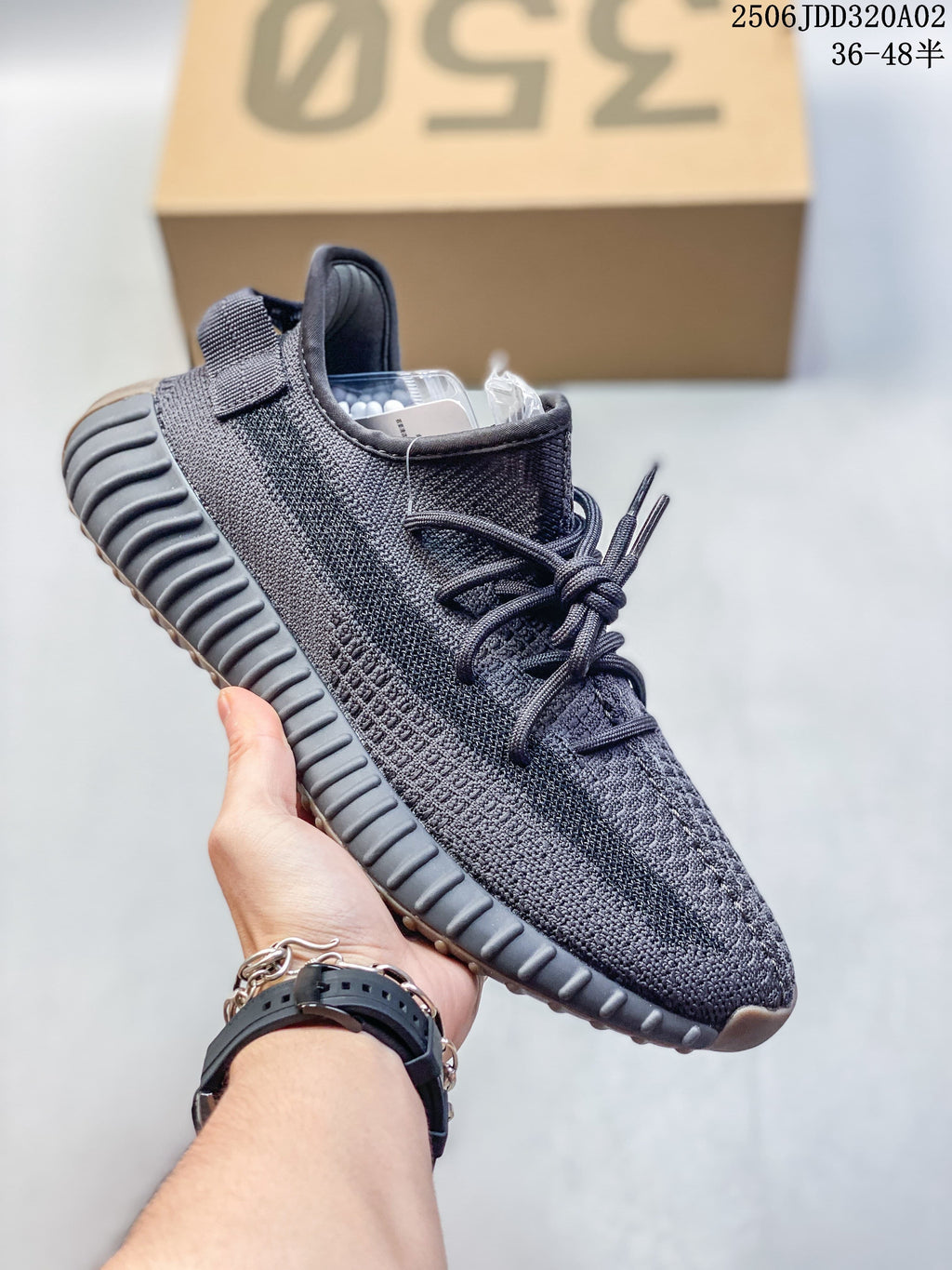 Close view of a dark Adidas Yeezy-style sneaker with laces and ribbed sole