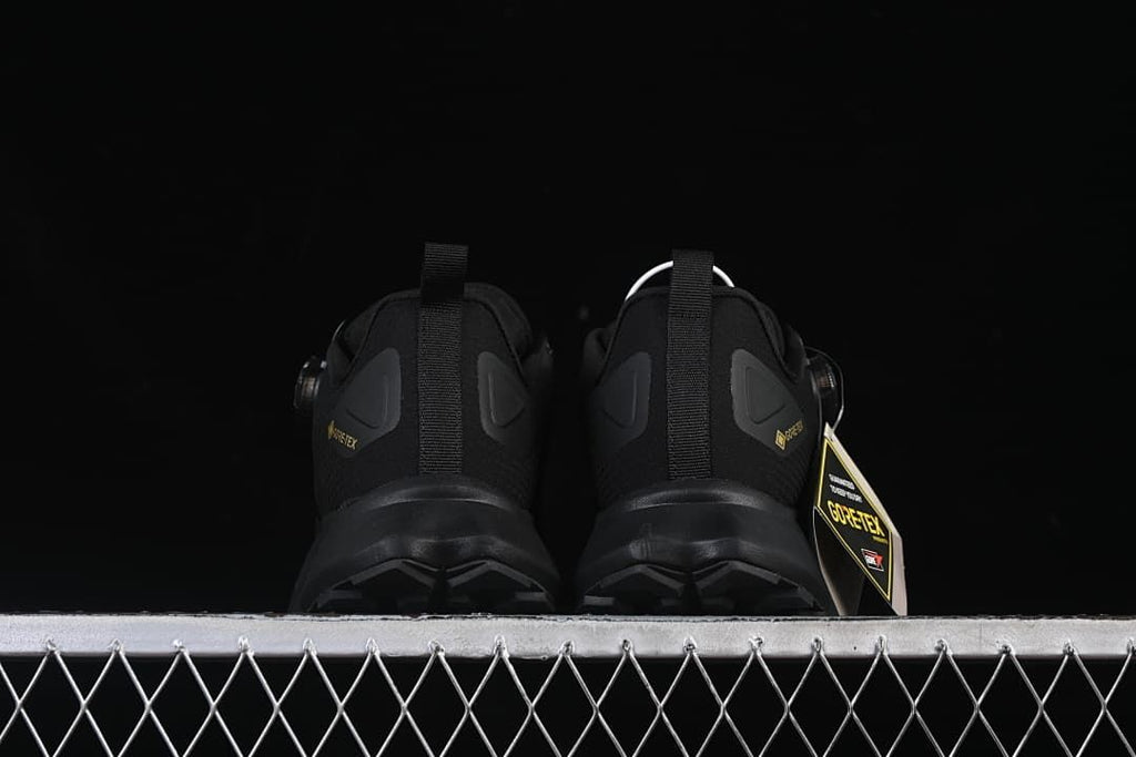 Rear view of both shoes showing heel details and lugged outsoles.