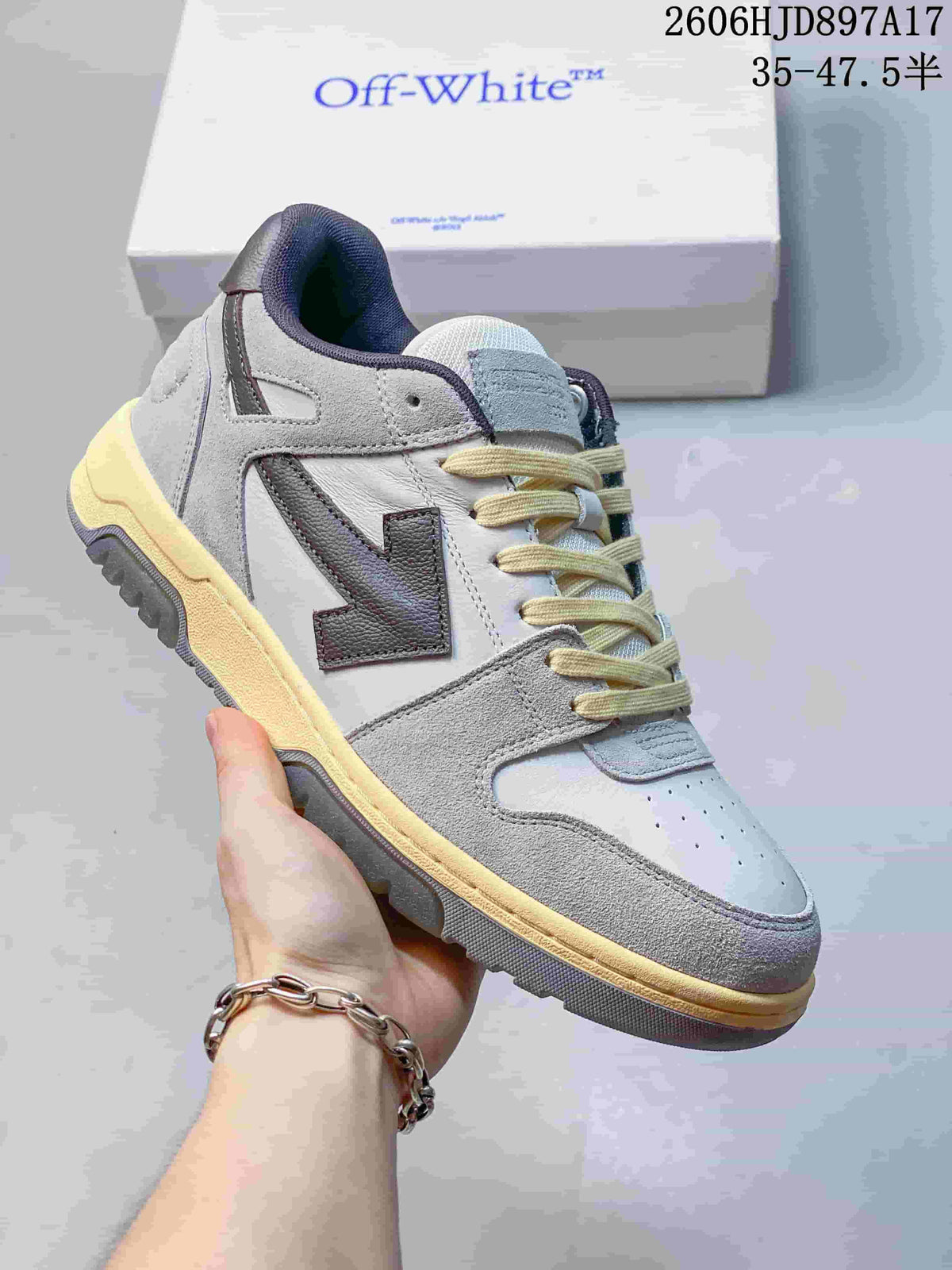 Angled side view of the low-top sneaker with grey overlays and contrasting dark side detail