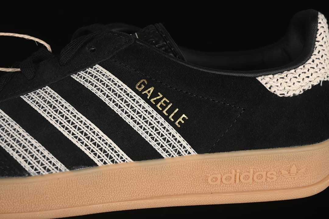 Side detail of black Gazelle Indoor sneaker with cream stripes, gold lettering and gum sole.