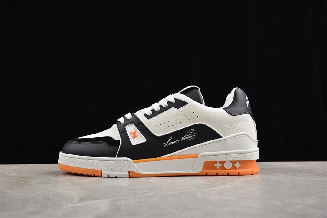 Side profile of the white, black, and orange LV Trainer sneaker