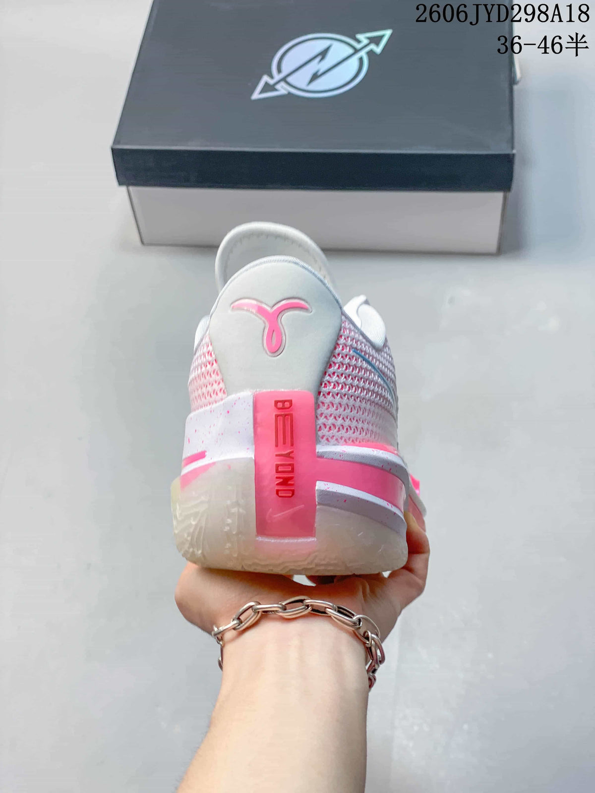 Rear view showing the pink heel details and textured side panels.