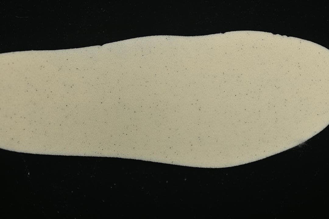 Close-up of a light cream shoe insert.