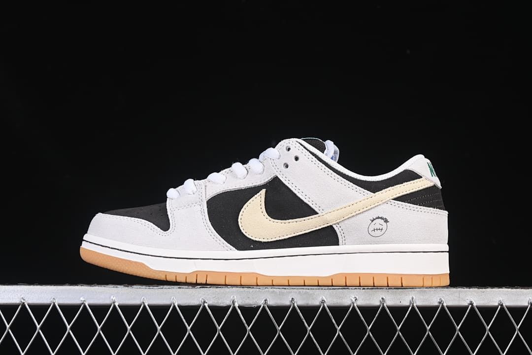 Side view of a Nike SB Dunk Low Pro sneaker in black, light neutral, and cream.