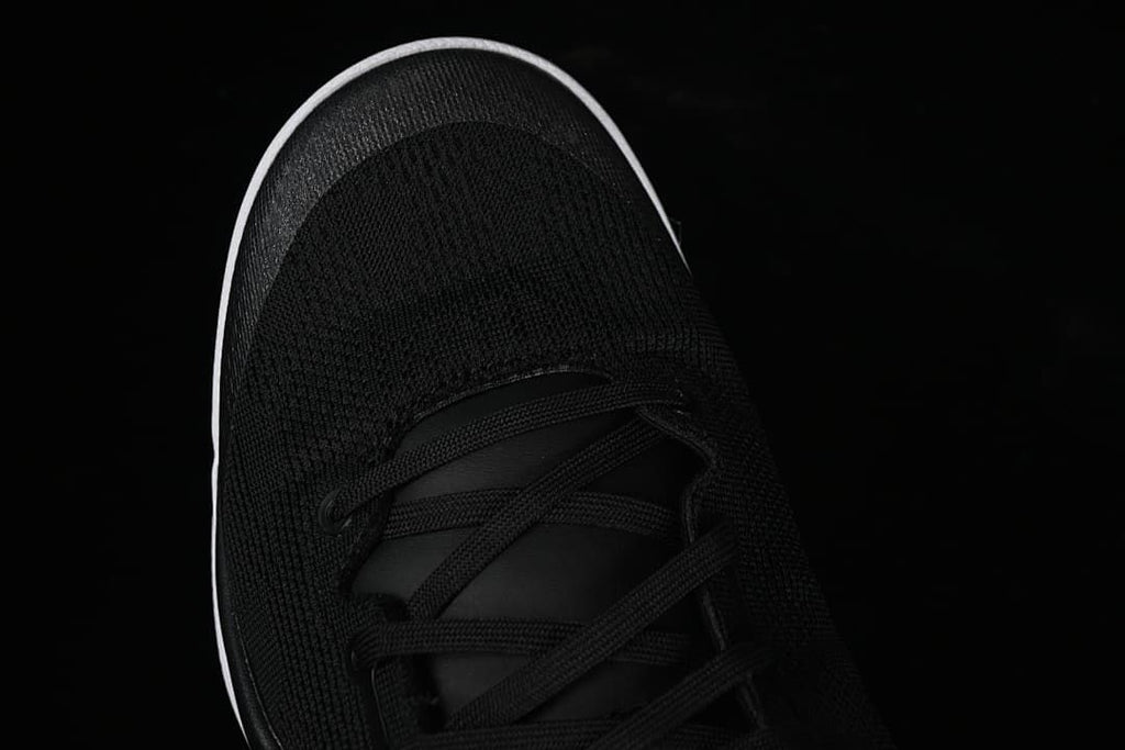 Top view of black mesh-like toe and lace area