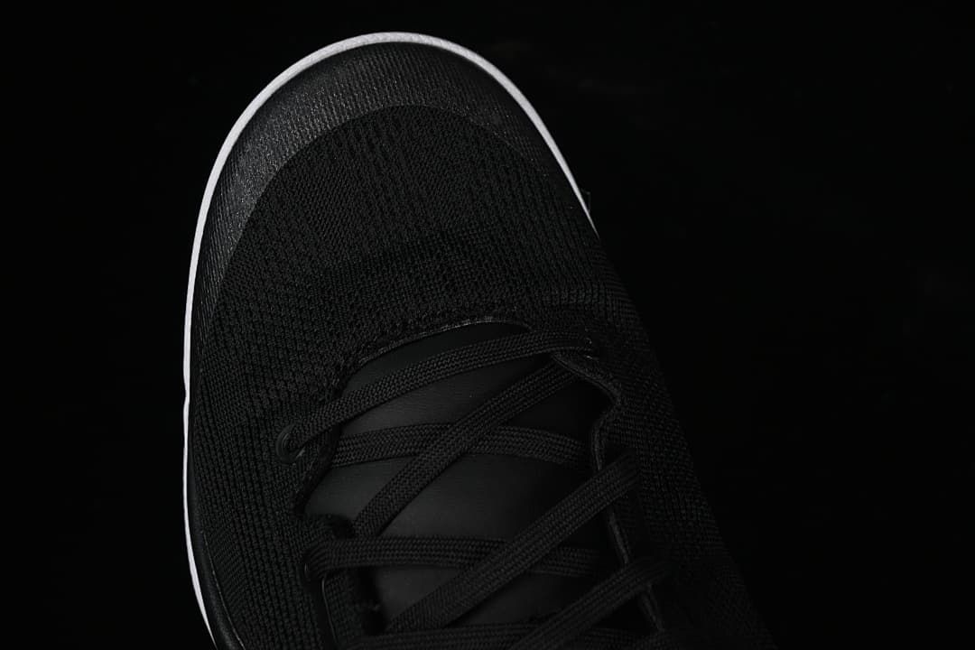 Top view of black mesh-like toe and lace area