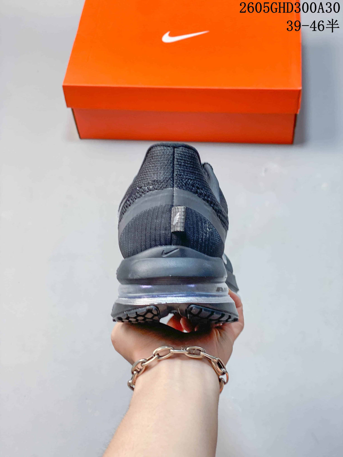Rear view of the charcoal running shoe showing the heel and cushioned sole.