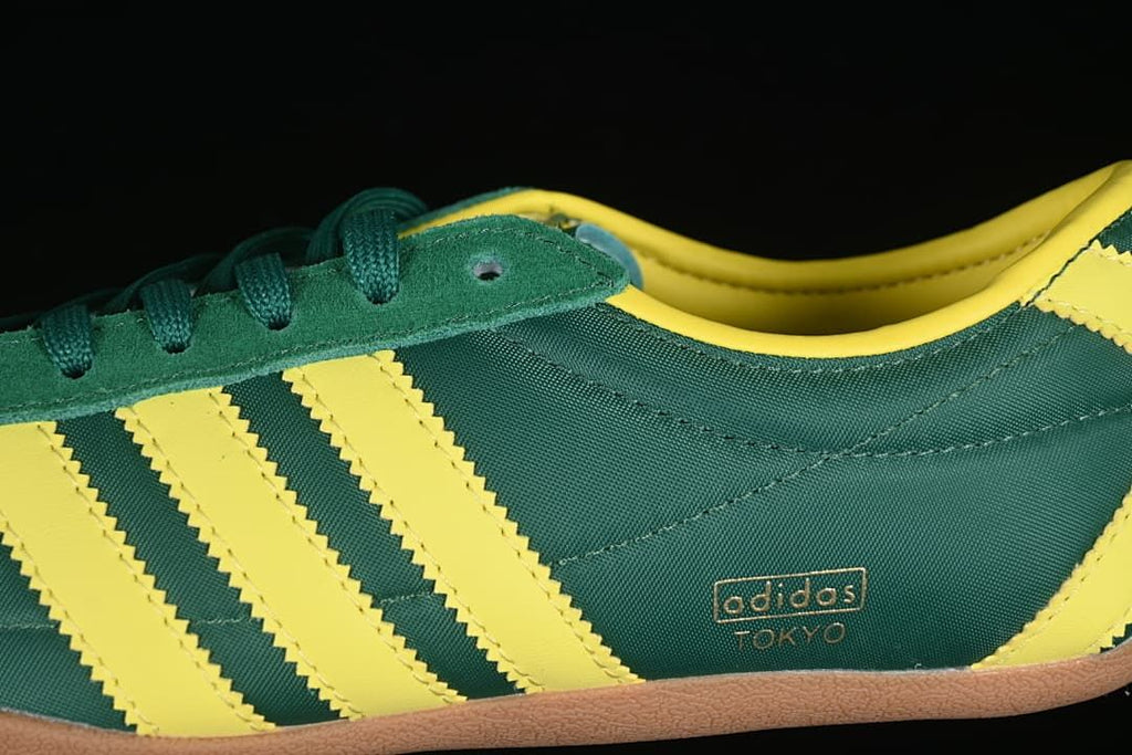 Side detail showing yellow stripes and Tokyo text on the green upper