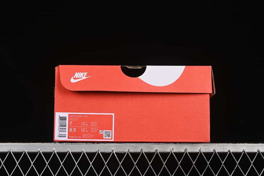 Shoebox label identifying Nike Dunk Low, style code FQ8249-104, and sample size details