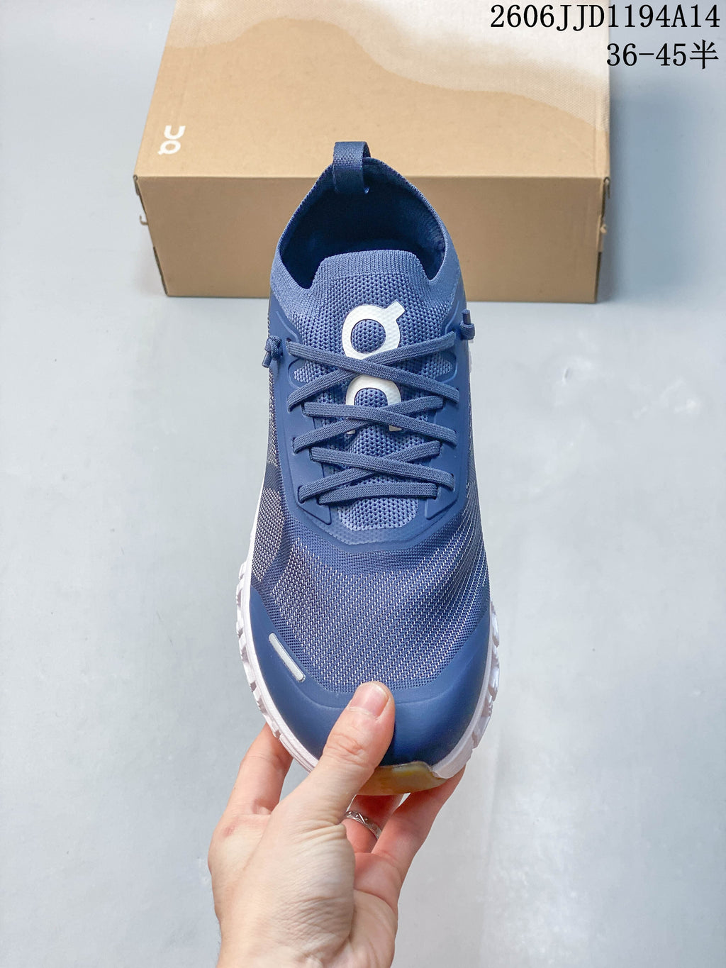 Top view of a blue On Cloud 6 Versa sneaker showing its lace-up front and patterned upper.