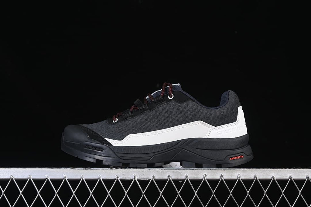 Side view of a black and white Salomon X-ALP outdoor shoe with burgundy laces.