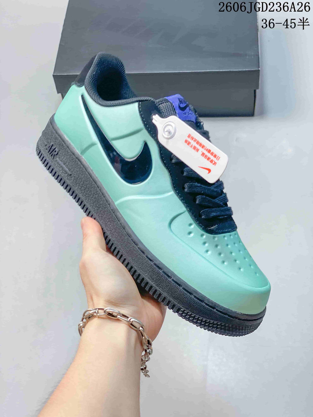 Side view of a mint green Nike Air Force 1 '07 Low sneaker with navy Swoosh and dark sole