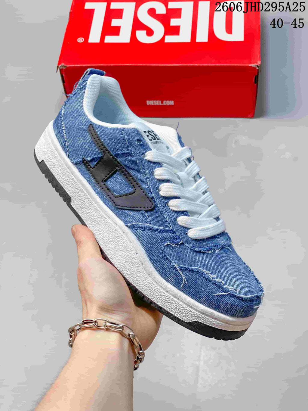 Close-up of a blue distressed denim-style low-top sneaker with contrasting side logo