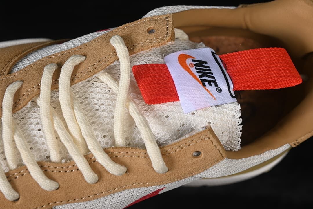 Top close-up of cream laces and tongue label with red pull tab