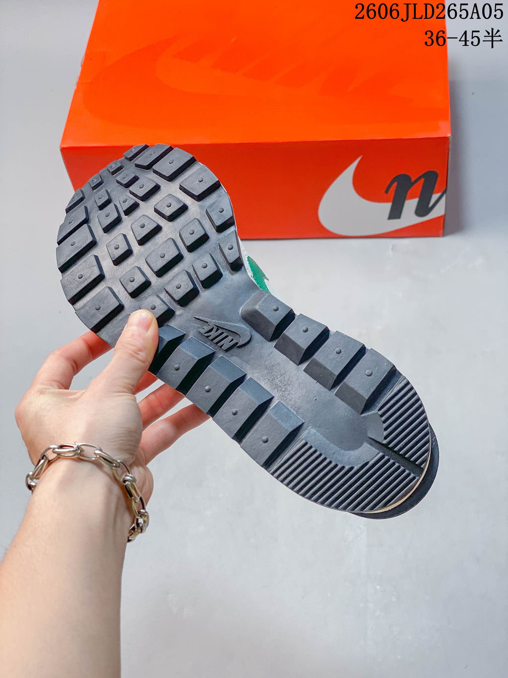 Close-up of the dark patterned outsole on a Nike x sacai LDWaffle sneaker.