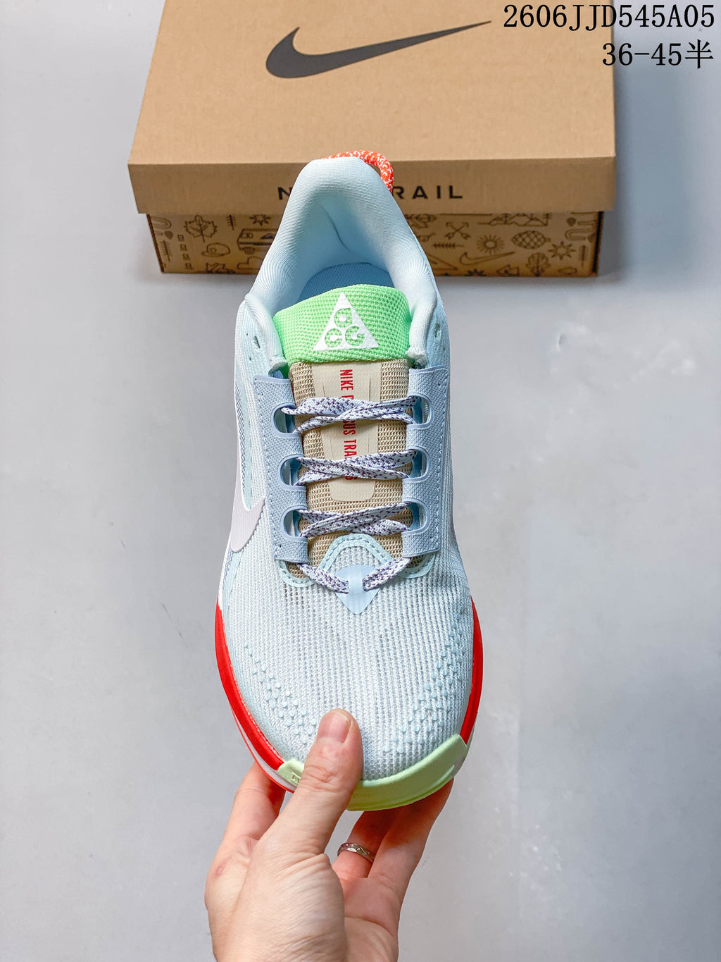 Top view showing the shoe's laces, green tongue detail, and light blue upper.