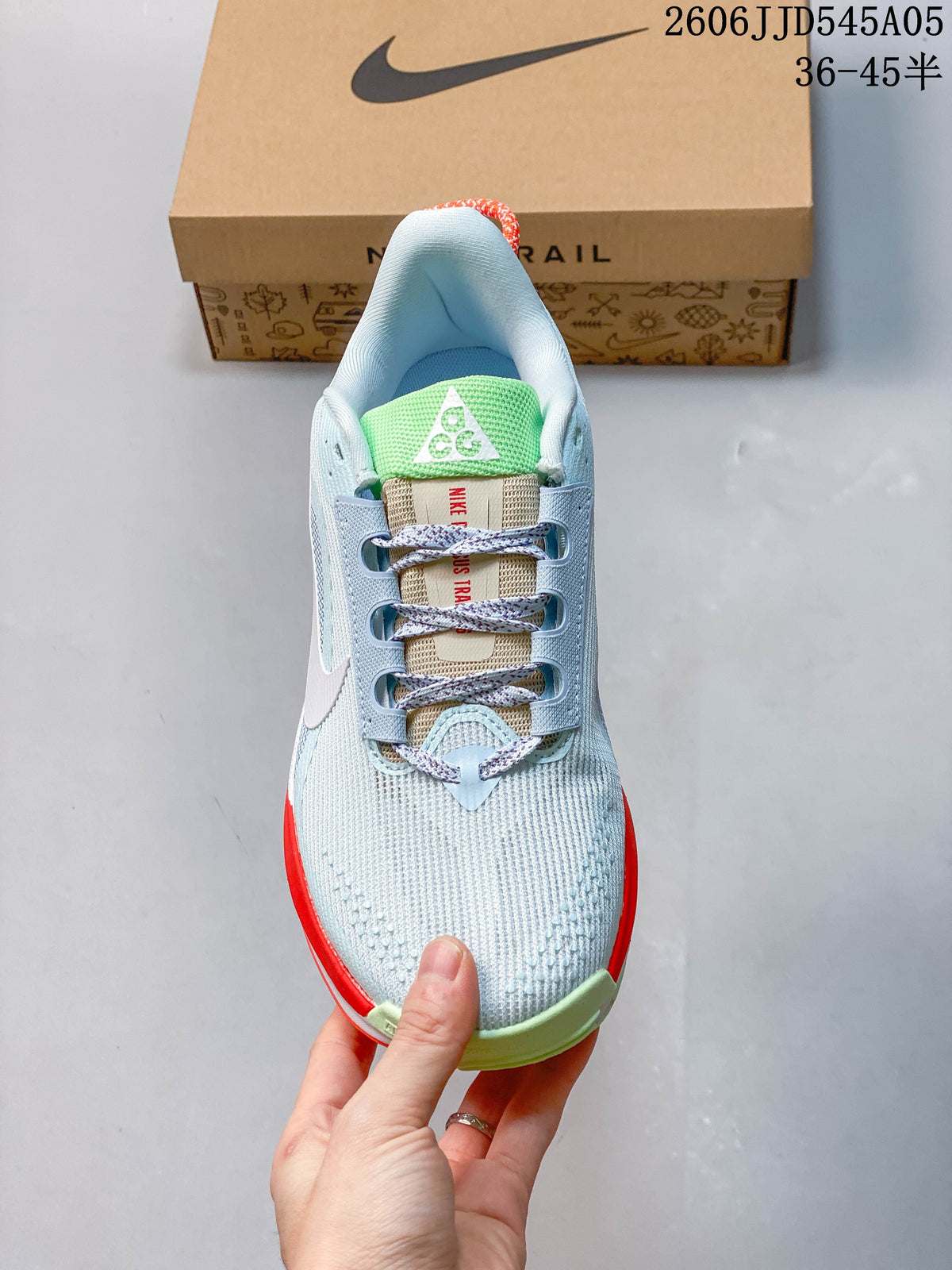 Top view showing the shoe's laces, green tongue detail, and light blue upper.