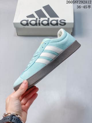 Side profile showing the pale sea blue upper, off-white stripes, and gum-colored midsole and outsole.