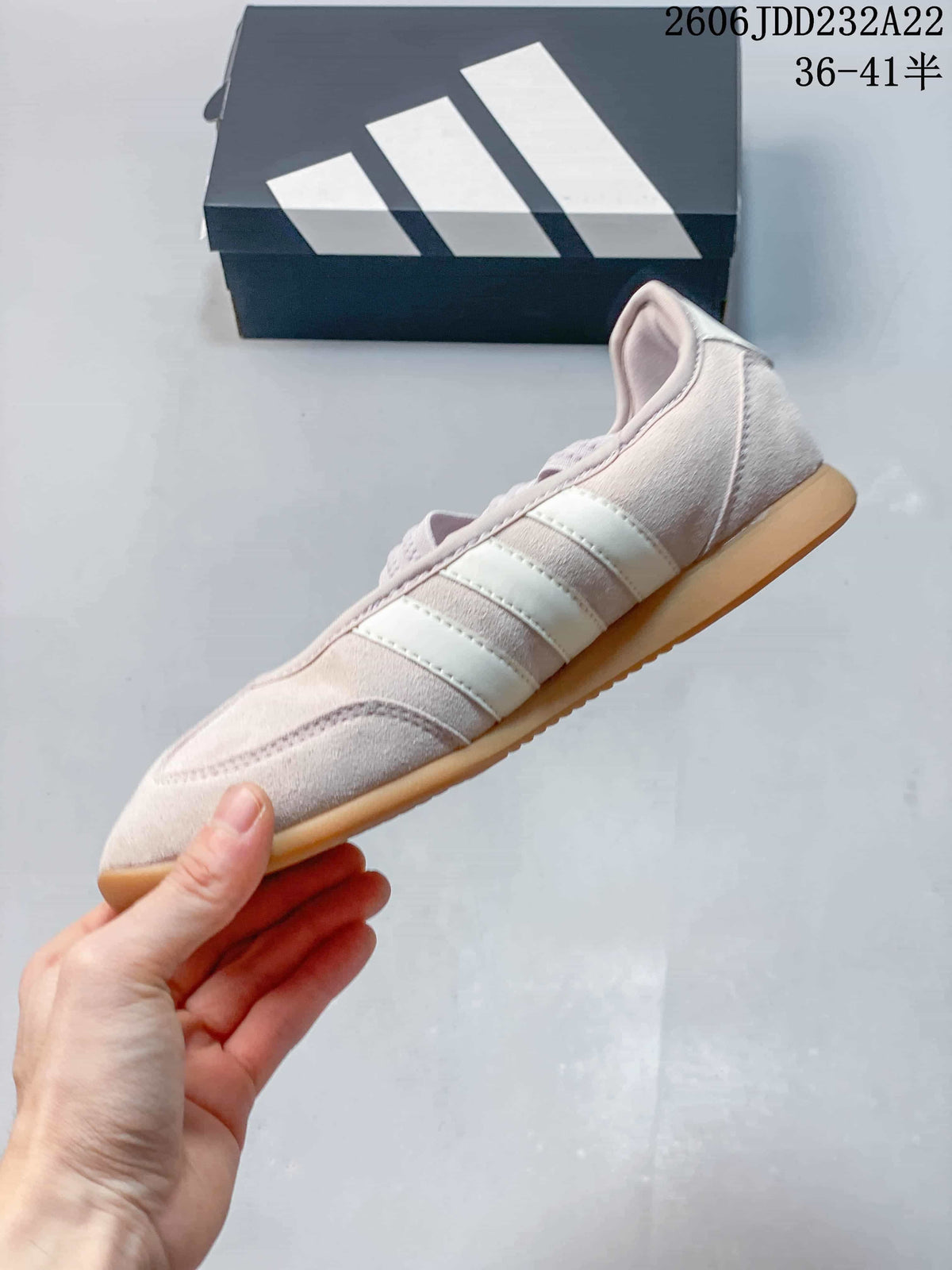 Side view showing the three light-colored stripes and gum-colored sole