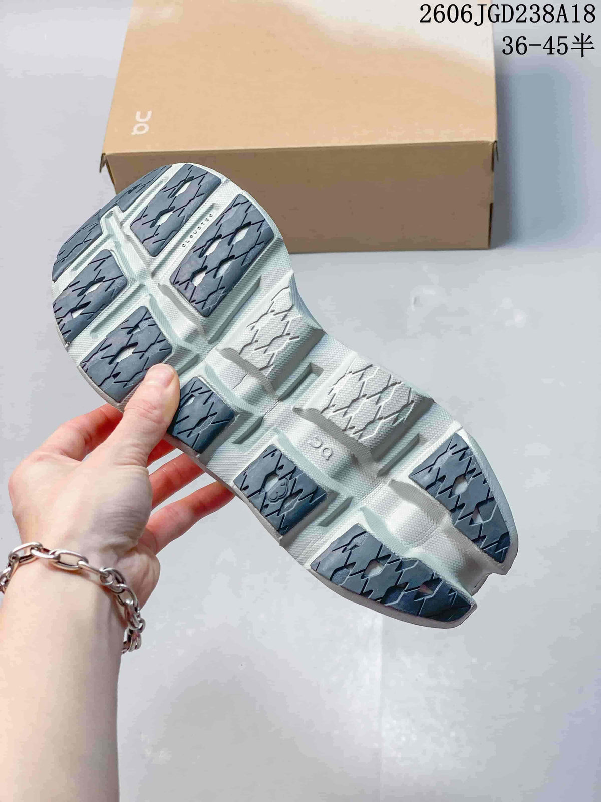 Close-up of the sneaker outsole showing segmented gray tread