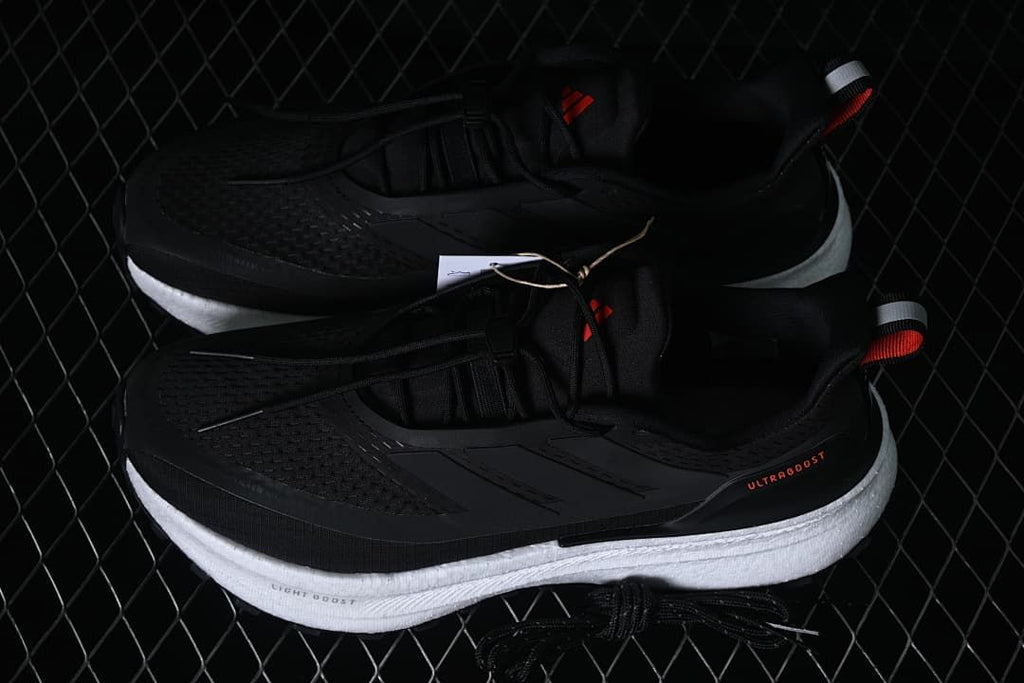 Pair of black adidas Ultraboost 5 shoes shown from above and the side.