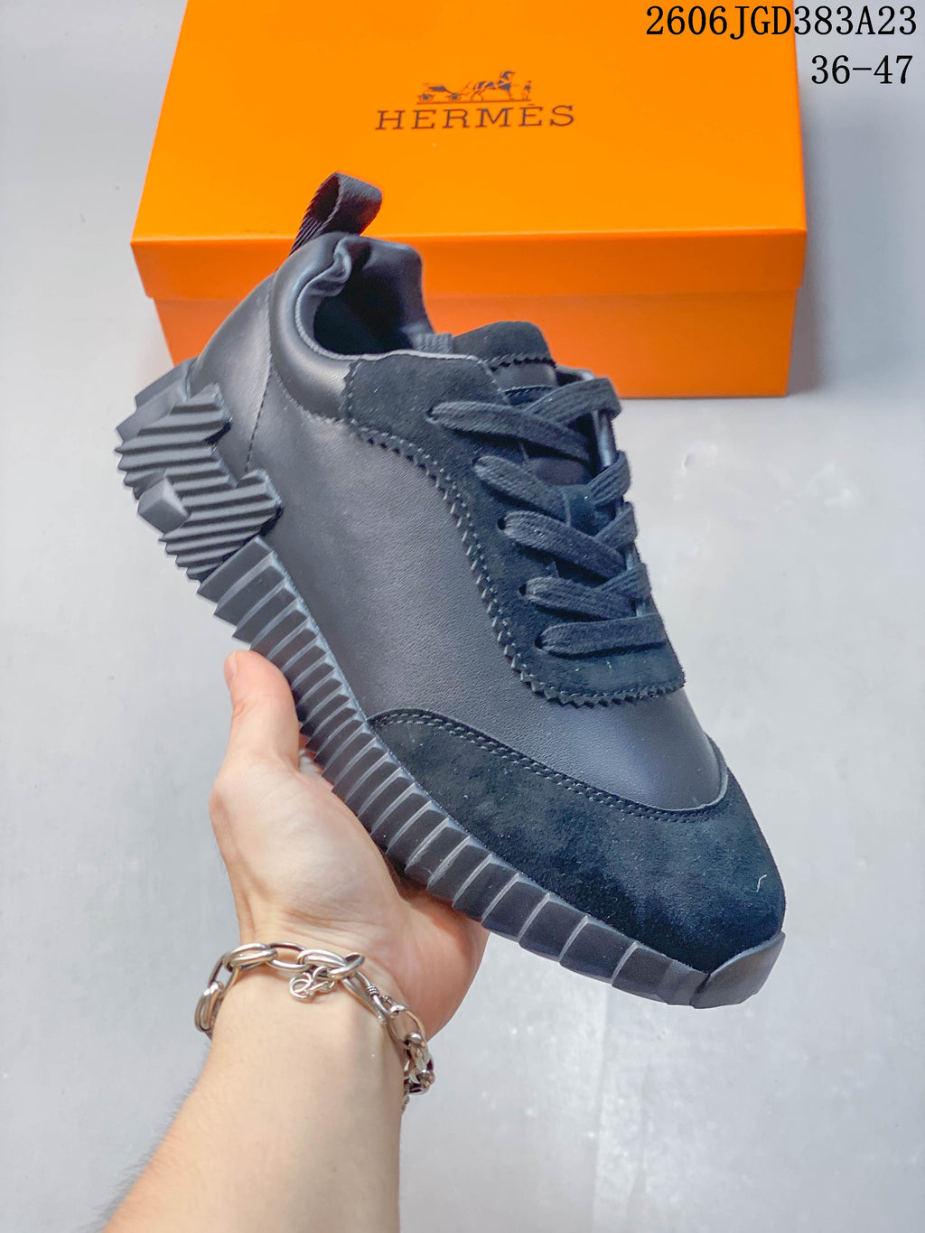 Angled side view of the dark navy low-top sneaker with contrasting textured sections.
