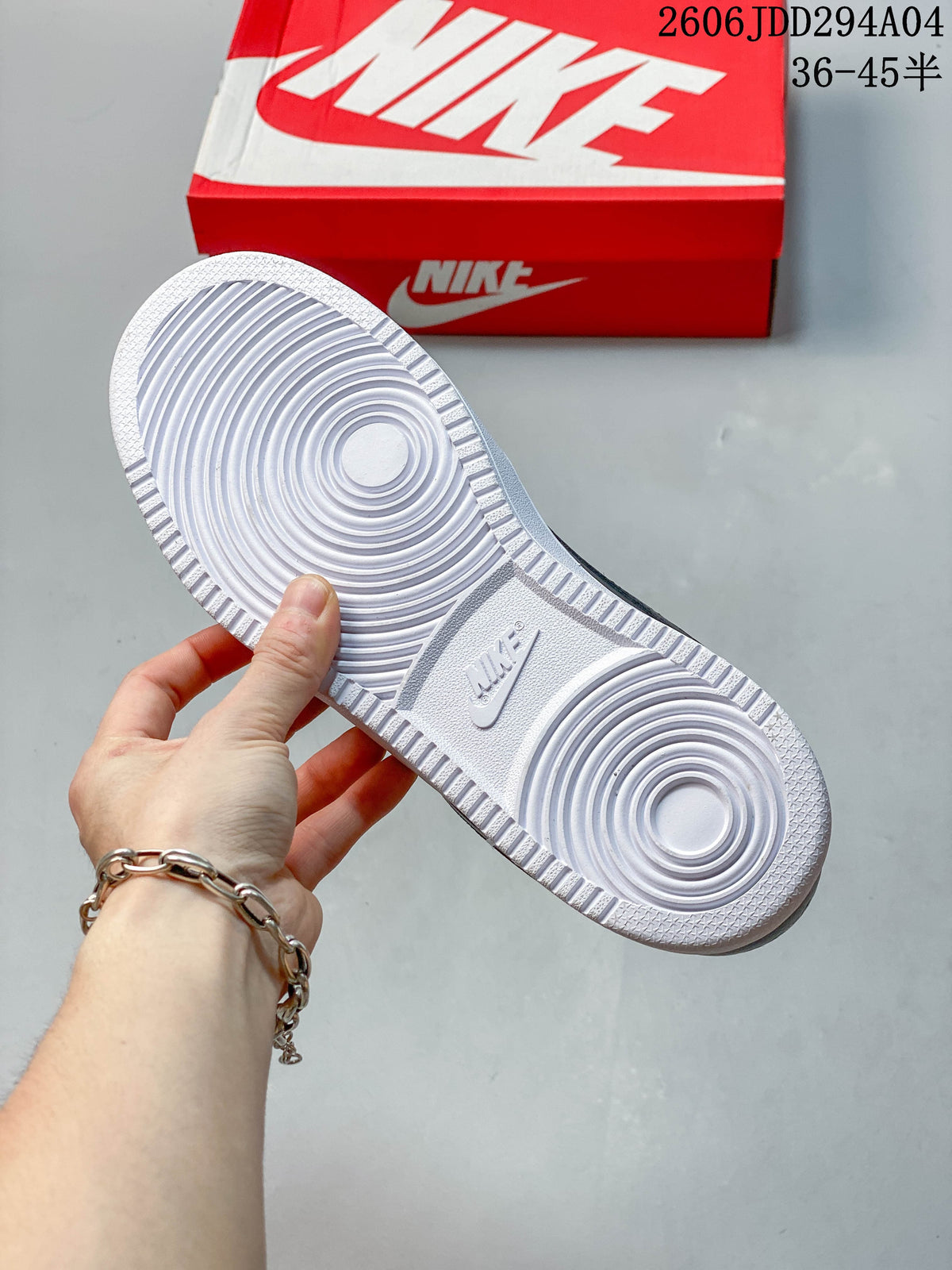 White outsole with circular tread pattern, shown beside a red shoebox