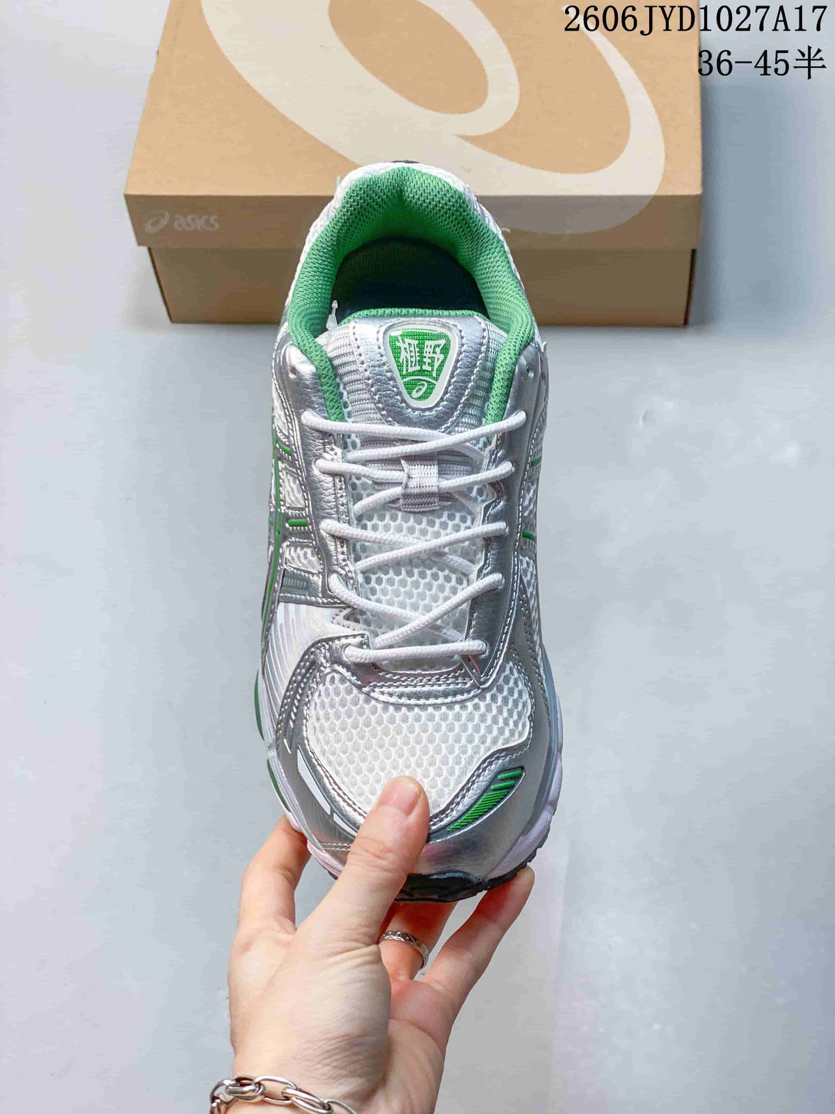 Top view of a sneaker showing white laces and green collar lining
