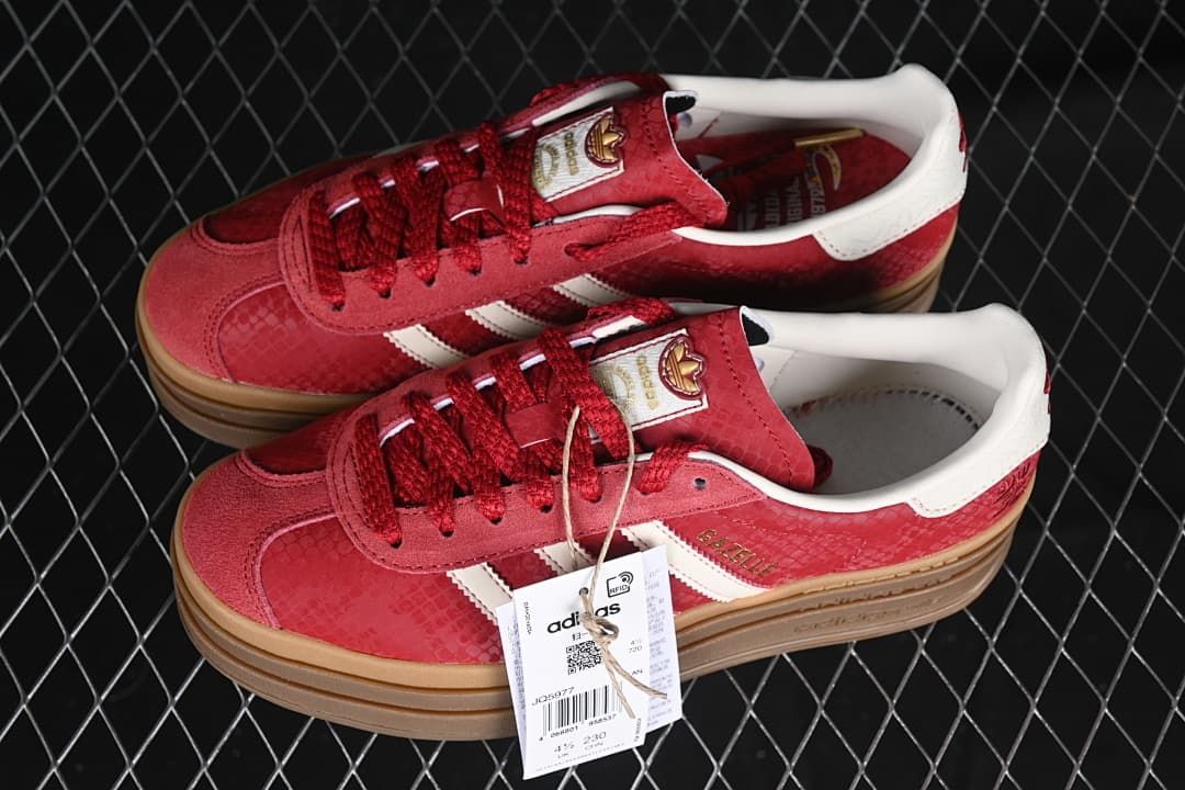 Pair of red Gazelle Bold sneakers with white stripes and raised gum-tone soles