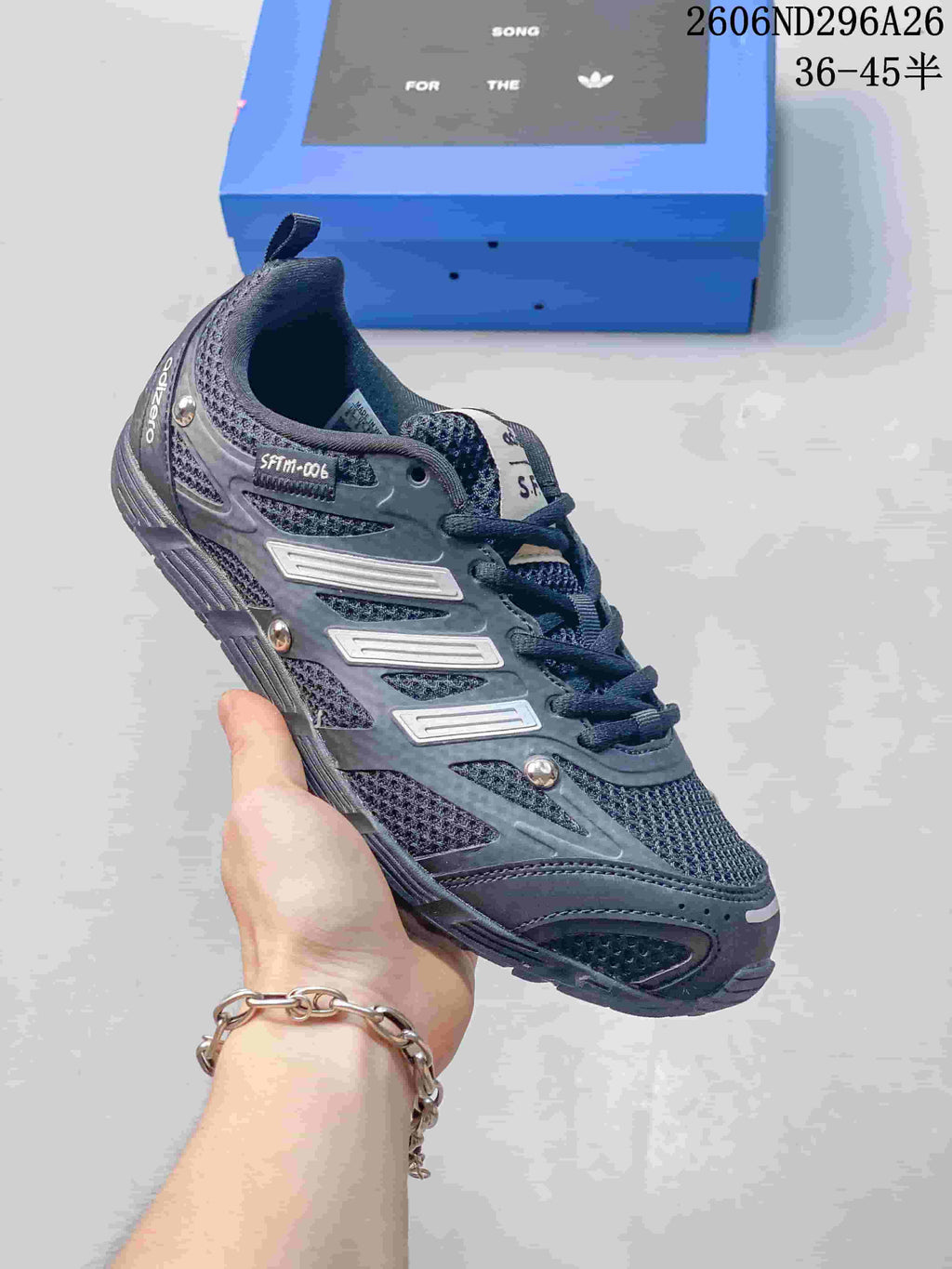 Dark charcoal Adidas Originals SFTM-006 low-top sneaker shown from the side