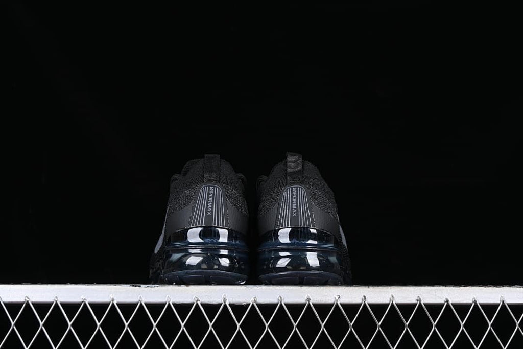 Rear view of the pair showing VaporMax heel panels and visible soles