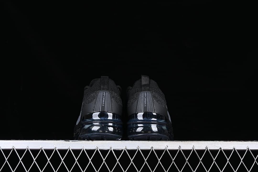 Rear view of the pair showing VaporMax heel panels and visible soles