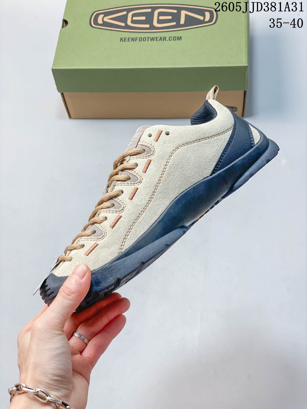 Side view of the beige and navy KEEN Jasper sneaker