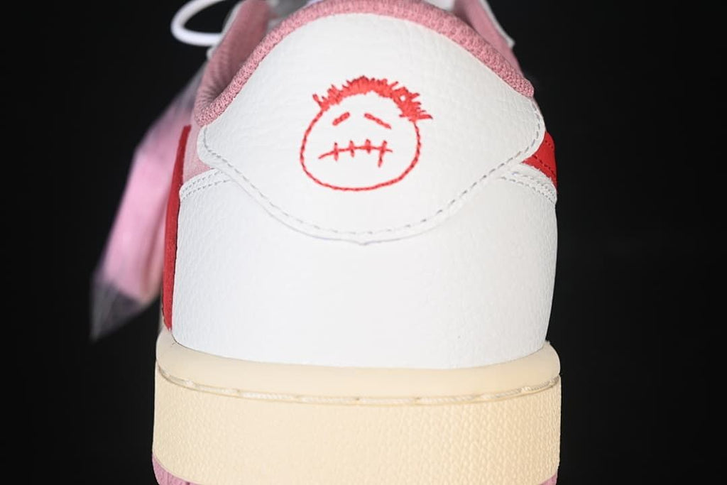 Heel close-up with white panel and red graphic embroidery
