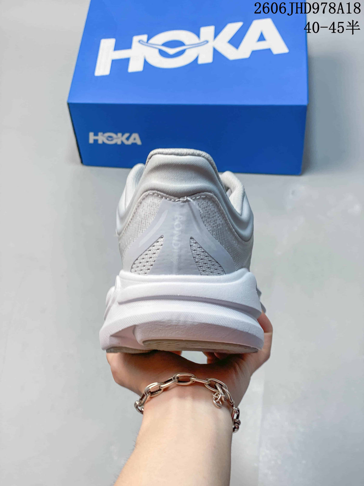 Rear view of a light gray-white HOKA Bondi 9 shoe