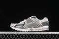 Side view of grey, black and off-white Nike Zoom Vomero 5 SP sneaker.