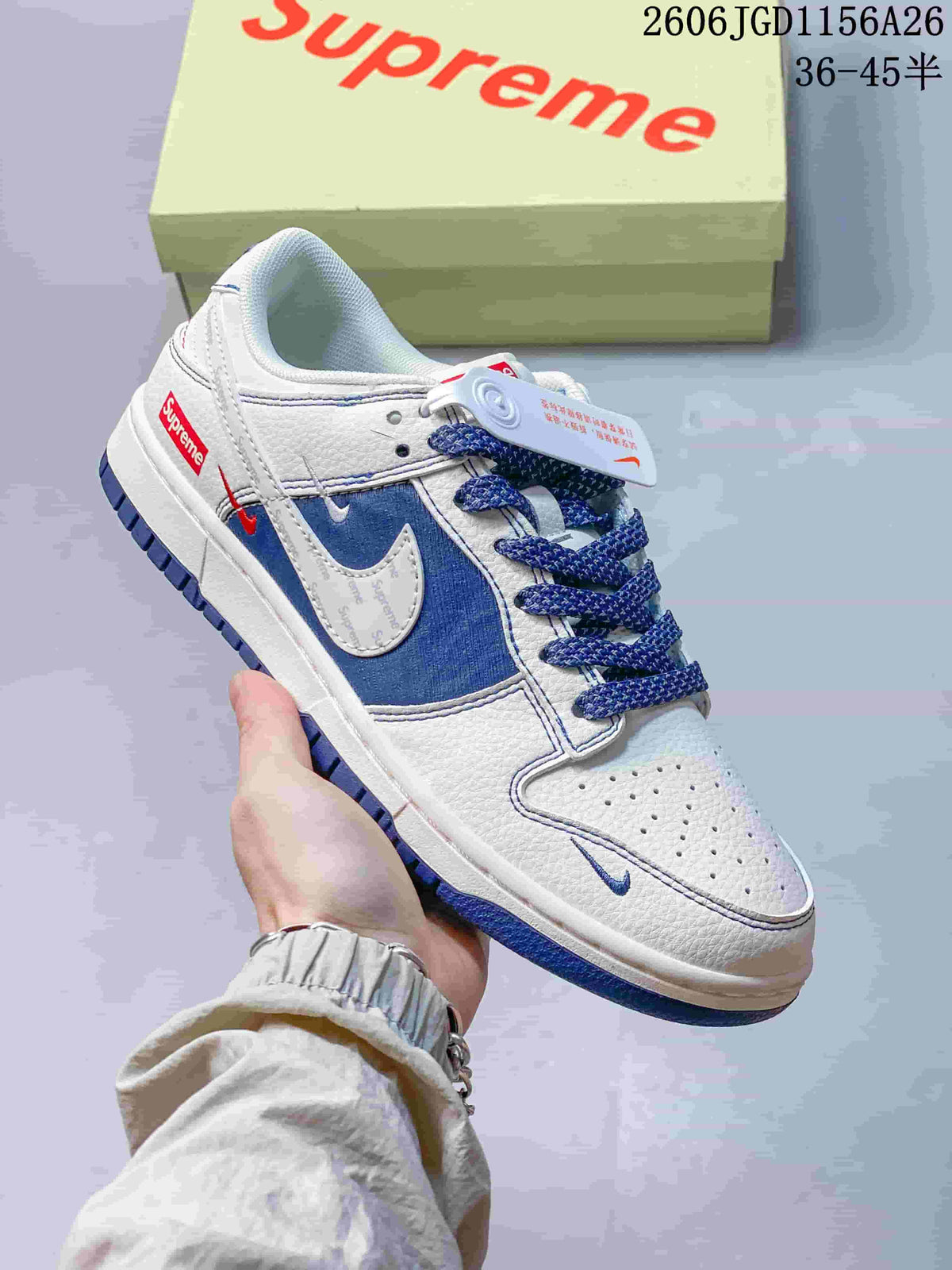 Close-up of a white low-top sneaker with blue patterned panels, blue laces, and perforated toe