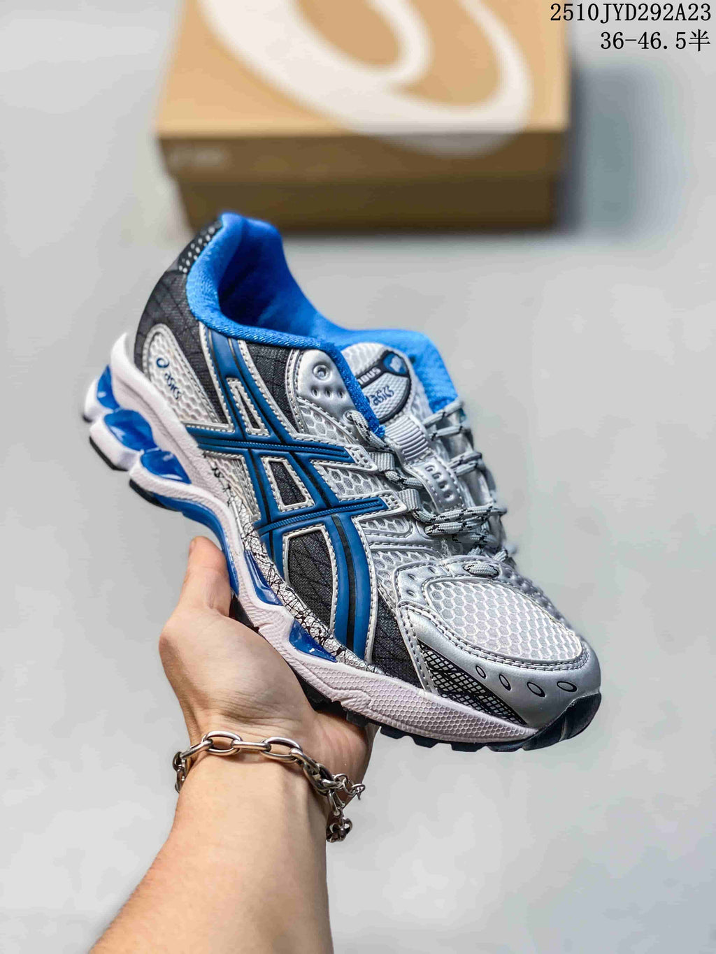 Silver and blue ASICS Gel-Nimbus sneaker with blue collar and side accents.