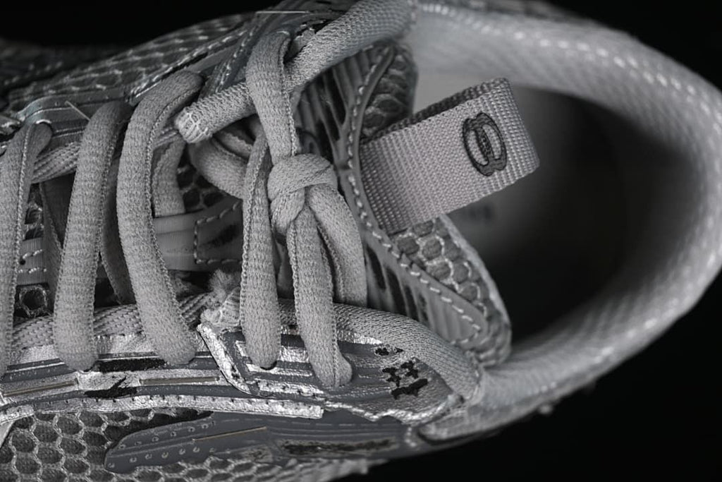 Close-up of the laces, tongue pull tab and upper panel details