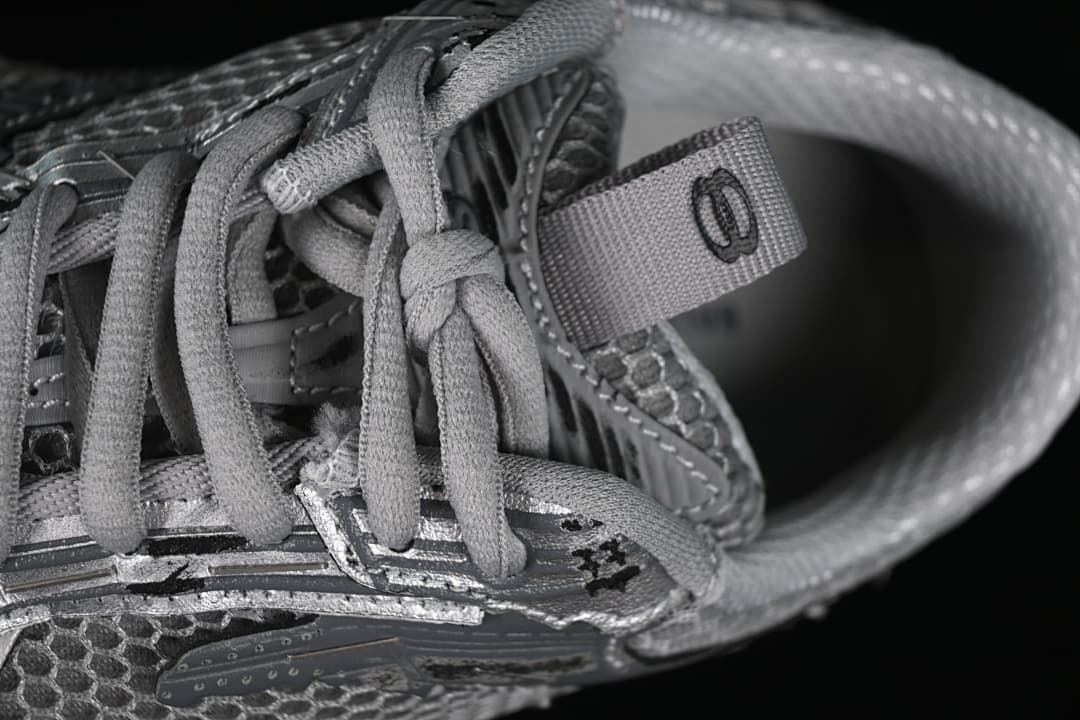 Close-up of the laces, tongue pull tab and upper panel details