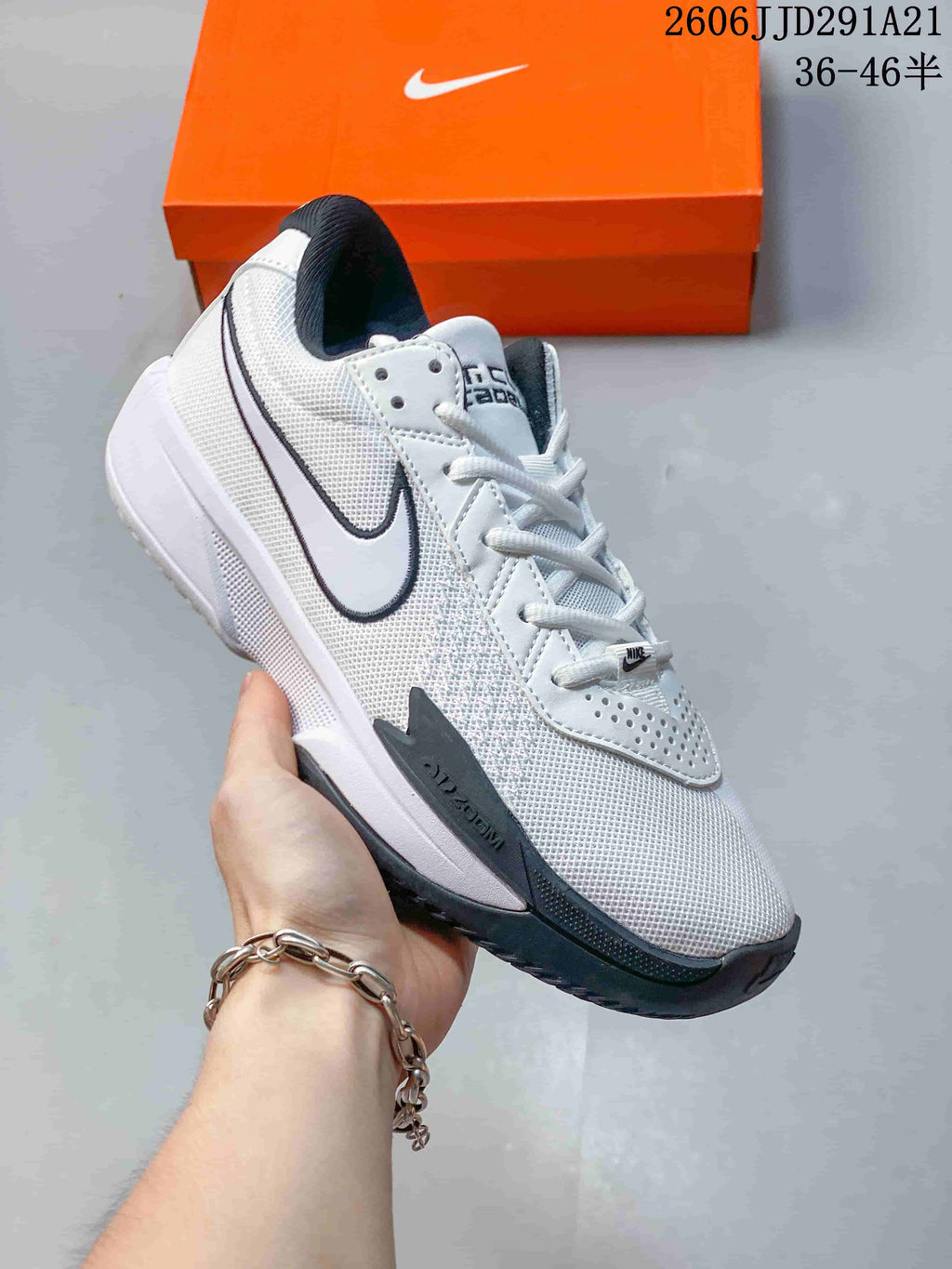 Angled side view of a white and dark gray Nike G.T. Cut 3 EP basketball shoe.