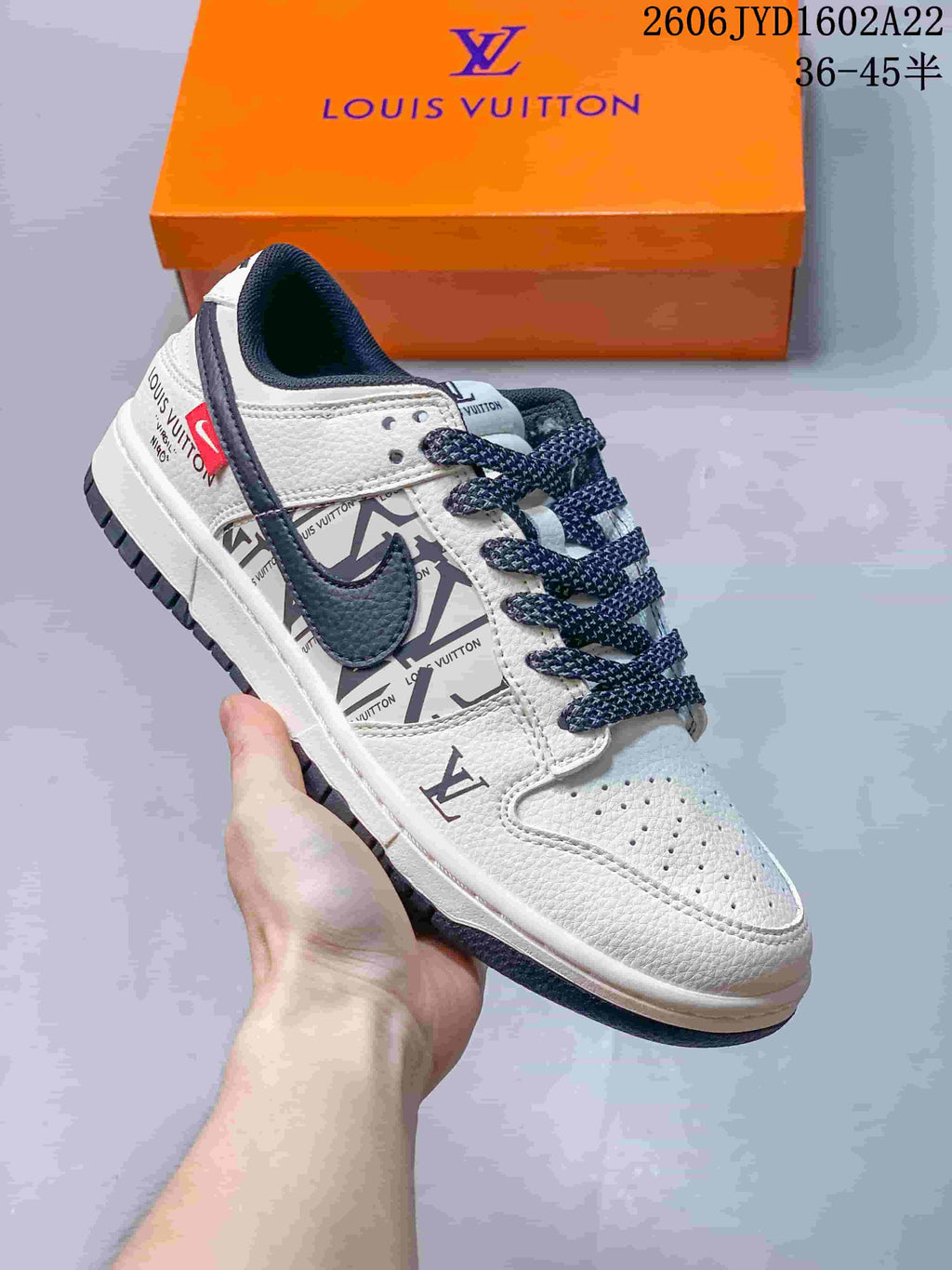 Angled side view of the white and navy sneaker with patterned panels