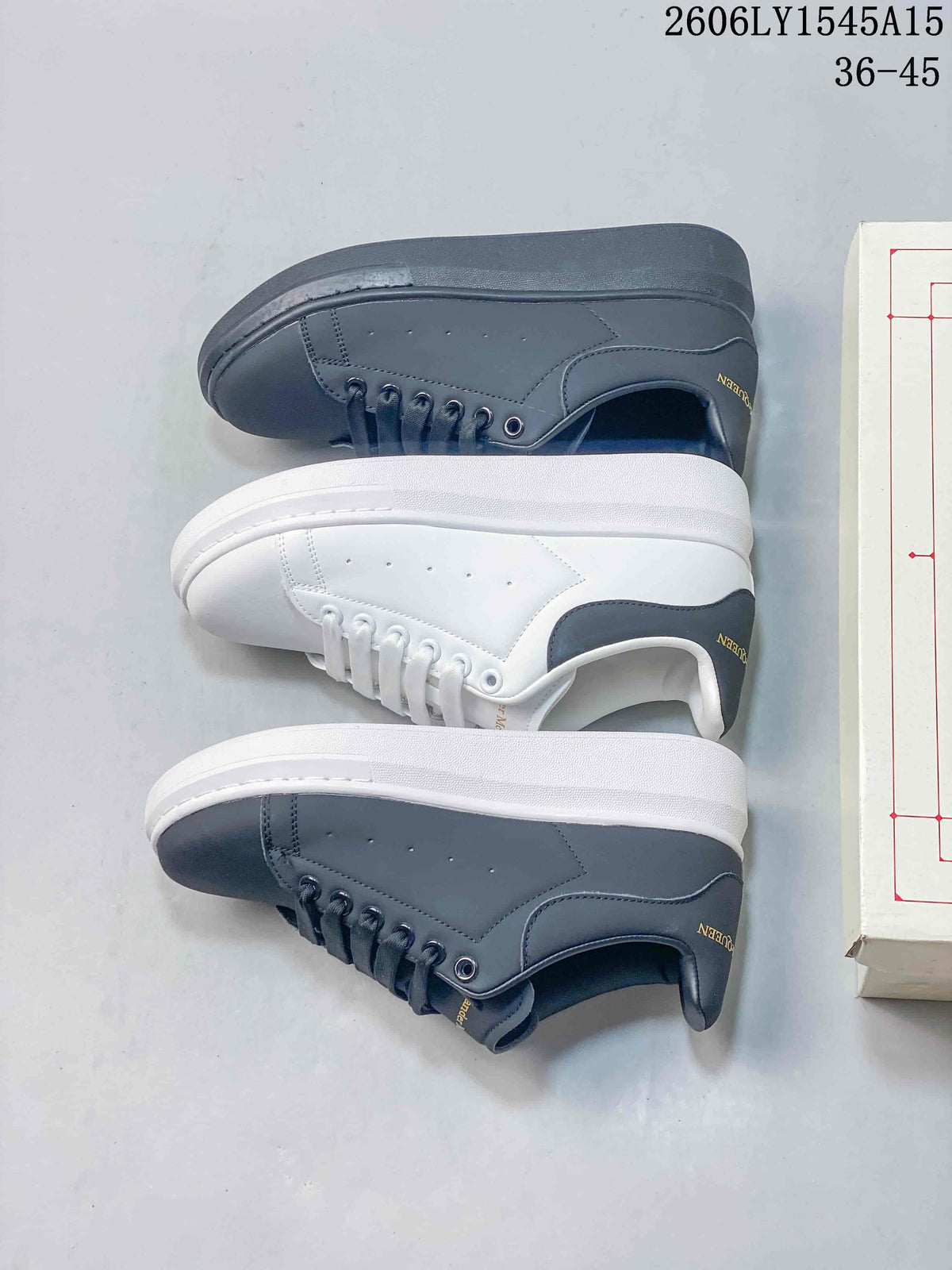 Three low-top sneakers shown from the side in dark grey, white with a grey heel, and grey with a white sole.