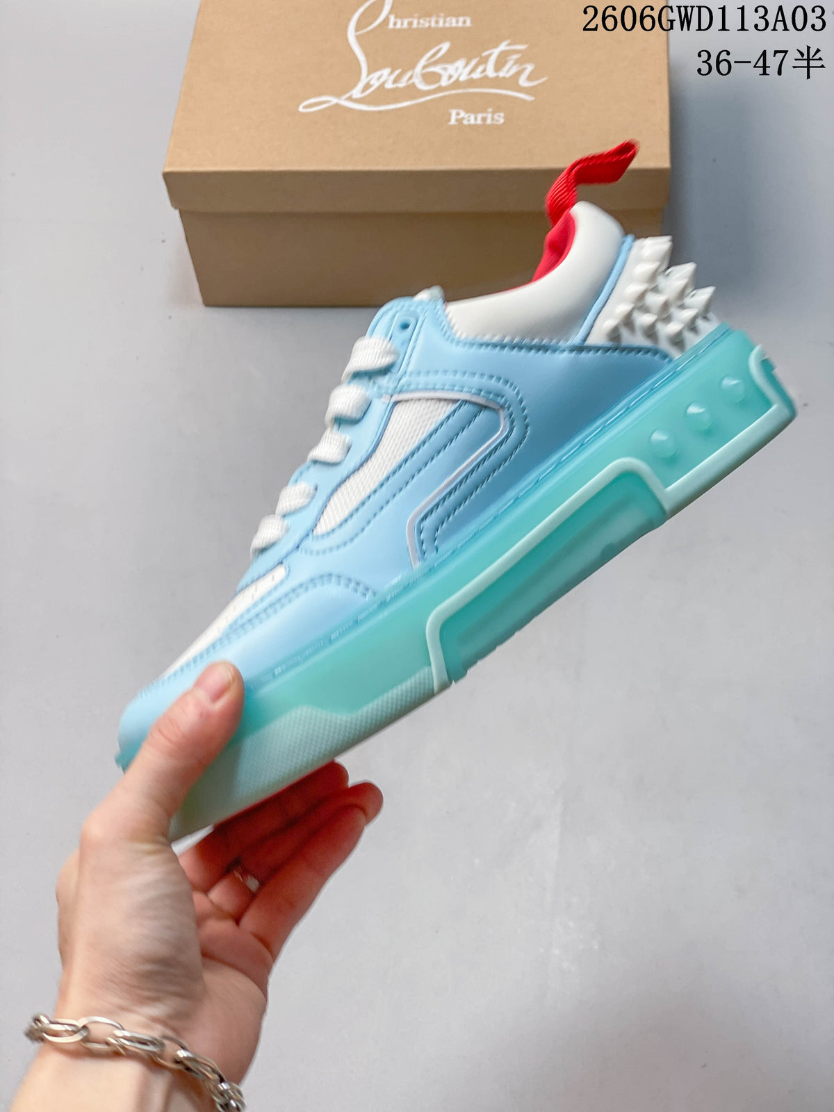 Side view of the light blue sneaker with white panels, red accents, and a turquoise-colored sole