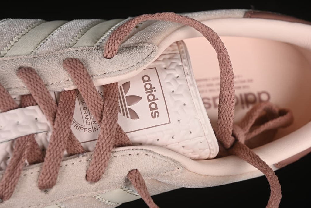 Close-up of mauve laces and adidas tongue label