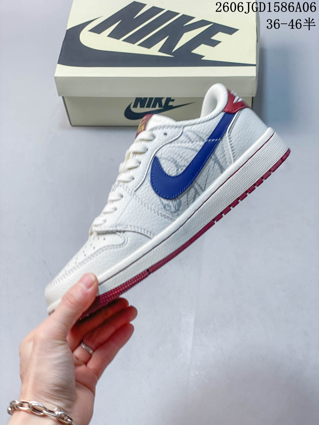 Side view of the white low-top sneaker with a blue side accent and red outsole