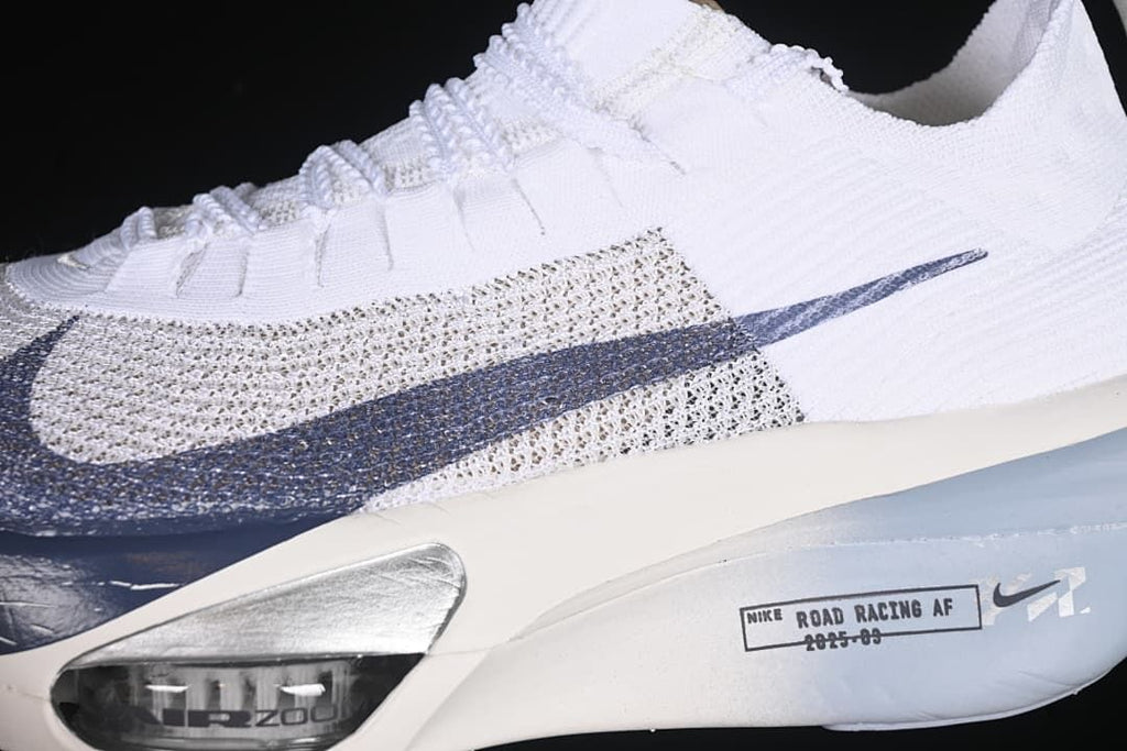 Close-up of the patterned upper, navy Swoosh and forefoot cushioning window