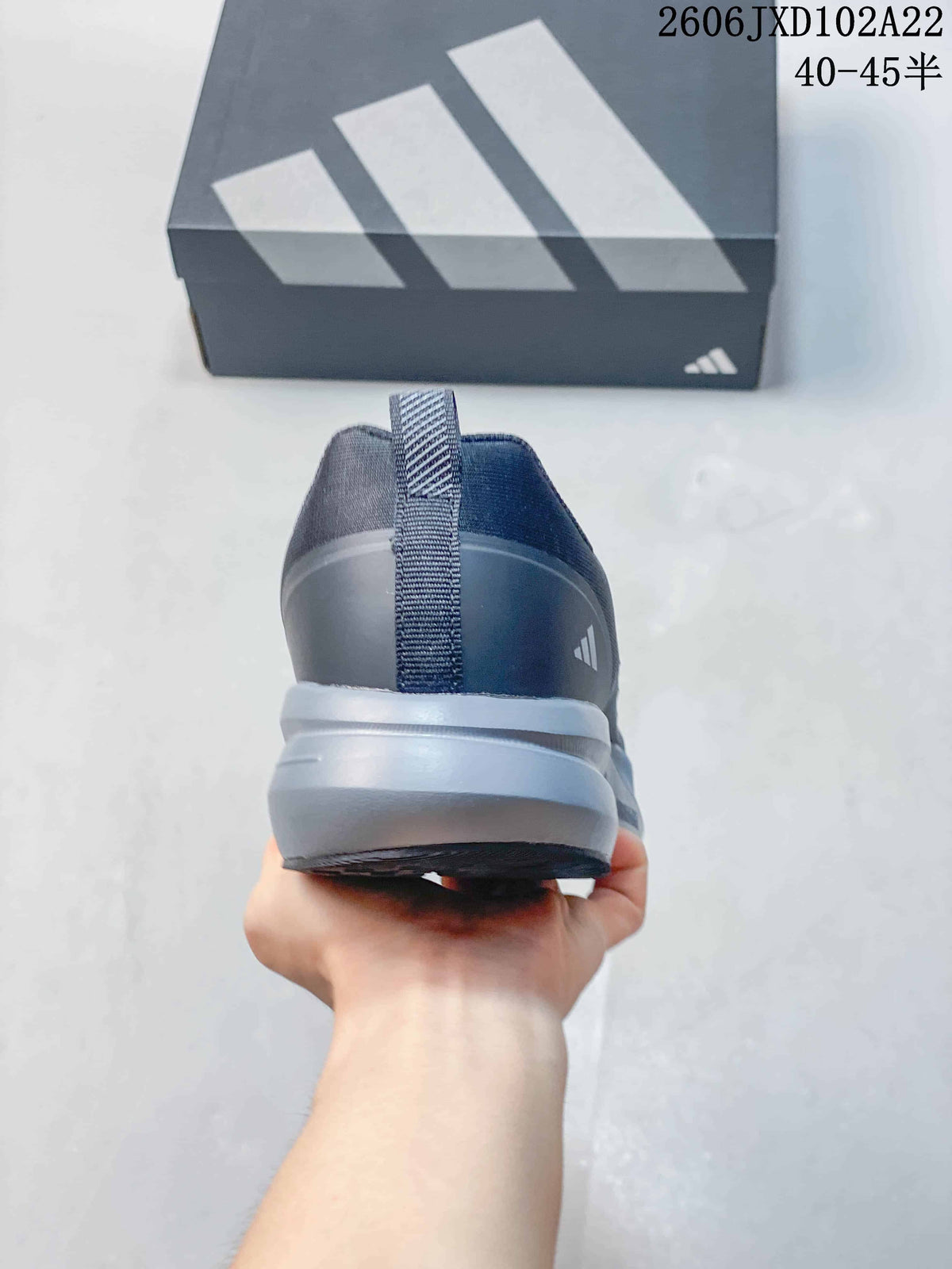 Rear view of a gray Adidas shoe with heel pull tab
