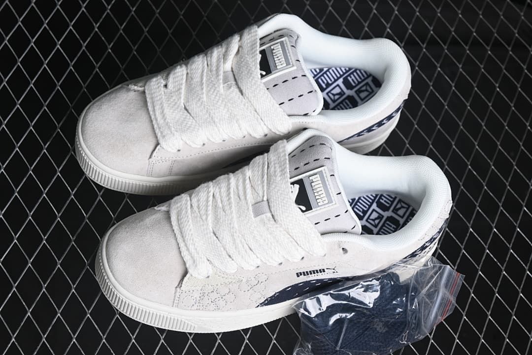 Pair of light-colored Puma Suede XL sneakers viewed from above.