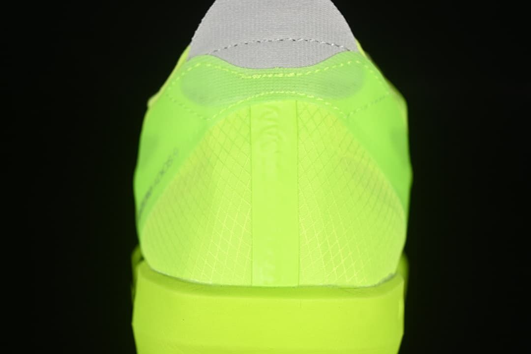 Rear view showing the heel and neon yellow upper